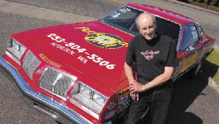 Bill Kost stands with his 1977 Oldsmobile Cutlass. Kost has raced the car for more than 30 years and piled up more than 40 wins.