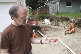 Forensic anthropologist Dr. James Chatters holds some of the human remains found at a construction site in the Highlands in May.