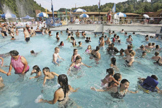 Throngs of people fill the wave pool at the Henry Moses Aquatic Center in 90-plus-degree heat Friday afternoon.