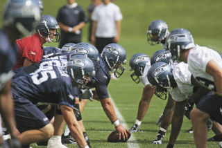 The Seahawks take the line of scrimmage in practice drills at their new facility in Renton.