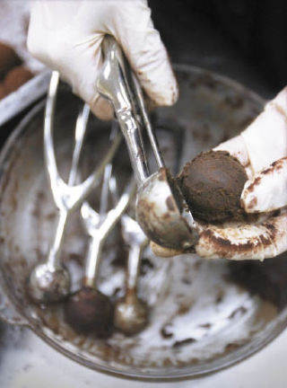 Annie Boyington scoops ganache while making truffles at Creative Kitchen Works.