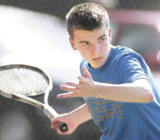 Sophomore co-captain Thomas Lowes eyes a forehand shot in practice at Liberty High School.