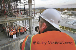Photographer Tom Owen takes photographs of Valley Medical Center administrators and dignitaries at a topping-off ceremony for the hospital’s new emergency and patient services tower Wednesday. The ceremony marked the completion of the building’s core structure. The $105-million tower is scheduled for completion at the end of 2009. At just over 196