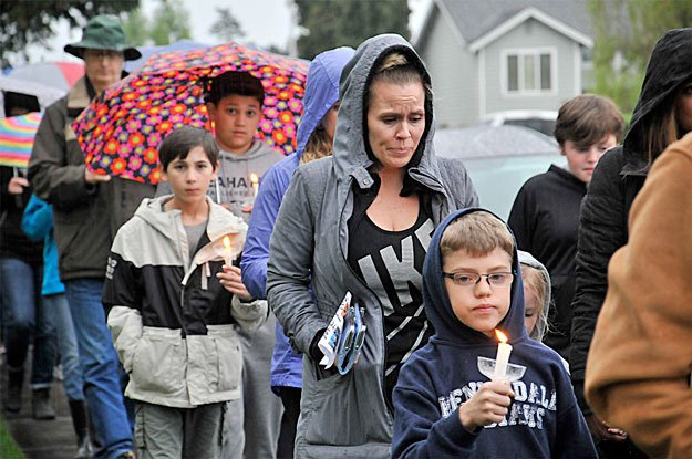 Mourners take part in a candlelight vigil and procession Tuesday night to remember Ingrid Lyne