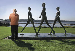 Phillip Levine stands next to his sculpture