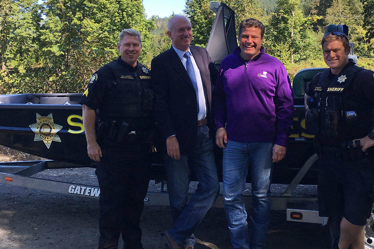 King County Sheriff John Urquhart and King County Flood Control District Chair Reagan Dunn are joined by members of the King County Sheriff’s Office Marine Rescue Dive Unit in front of the KCSO’s new river rescue boat. From left, Sgt. Mark Rorvik KCSO’s Marine Rescue Dive Unit, Sheriff Urquhart, Flood District Chair Dunn, KCSO Deputy Ben Callahan. (Courtesy photo)