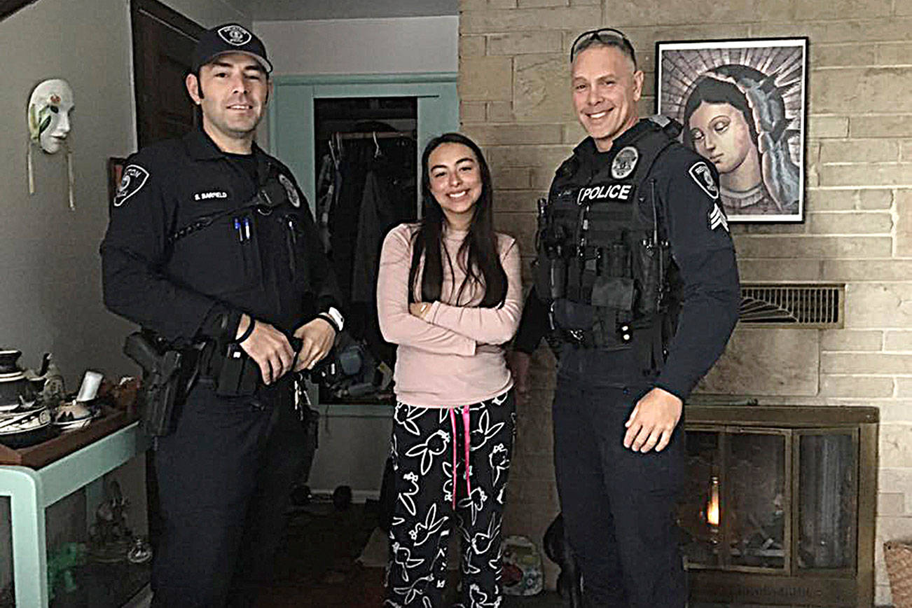 Tania Avila, center, poses with police officers whom she worked with to reunite a lost toddler with his family. (Courtesy photo)