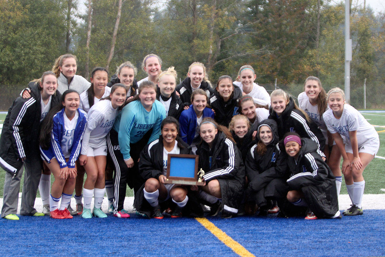 Liberty girls soccer team celebrates its 3-0 win over Cedarcrest Saturday to win the District 1/2 2A girls soccer tournament at Shoreline Stadium. The Patriots enter the state tournament as the No. 1 seed. (Sarah Brenden | Renton Reporter)