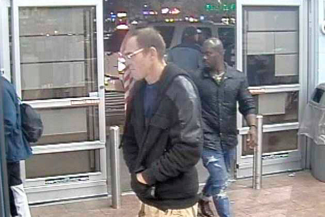 Renton Police Department is seeking public assistance to identify the man in the back (with the bald head). He allegedly groped a girl and attempted to lure girls from a Renton Walmart Dec. 10. (Courtesy photo)