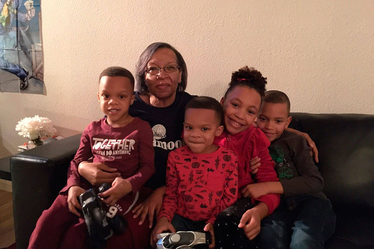 Jackie Thomas poses for a photo with her grandchildren. Thomas, who has worked as a police service specialist for 23 years, was diagnosed with stage four cancer last year. (Photo courtesy Renton Police Department)