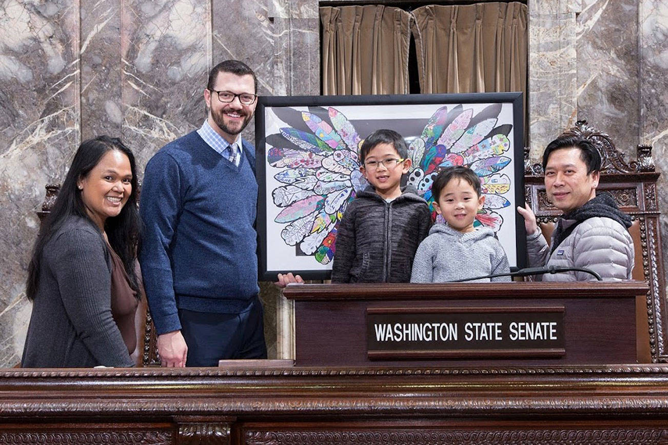Maplewood Heights first grader Jalen and his family made the trip to Fain’s Olympia office to deliver the art piece. COURTESY PHOTO