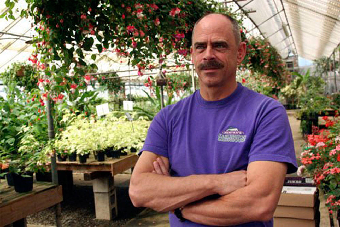 Ron Minter poses inside Minter’s Earlington Greenhouse Nursery before it closed in 2015. File photo