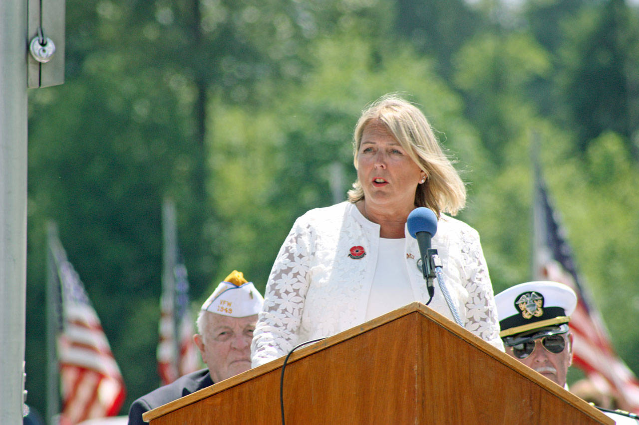 Monica McNeal, who lost her son in the war in Afghanistan, speaks to the crowd assembled for the ceremony at Tahoma National Cemetery on Monday. McNeal, the keynote speaker, is president of the Washington chapter of American Gold Star Mothers. MARK KLAAS, Kent Reporter