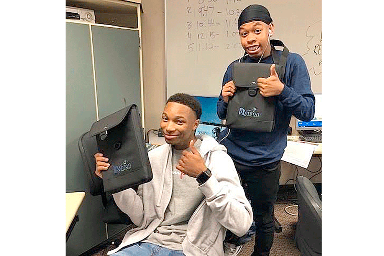Photo by Emma Austin                                Renton students Aaron Jenkins, left, and Isaiah Little, right, show off their Chromebooks.