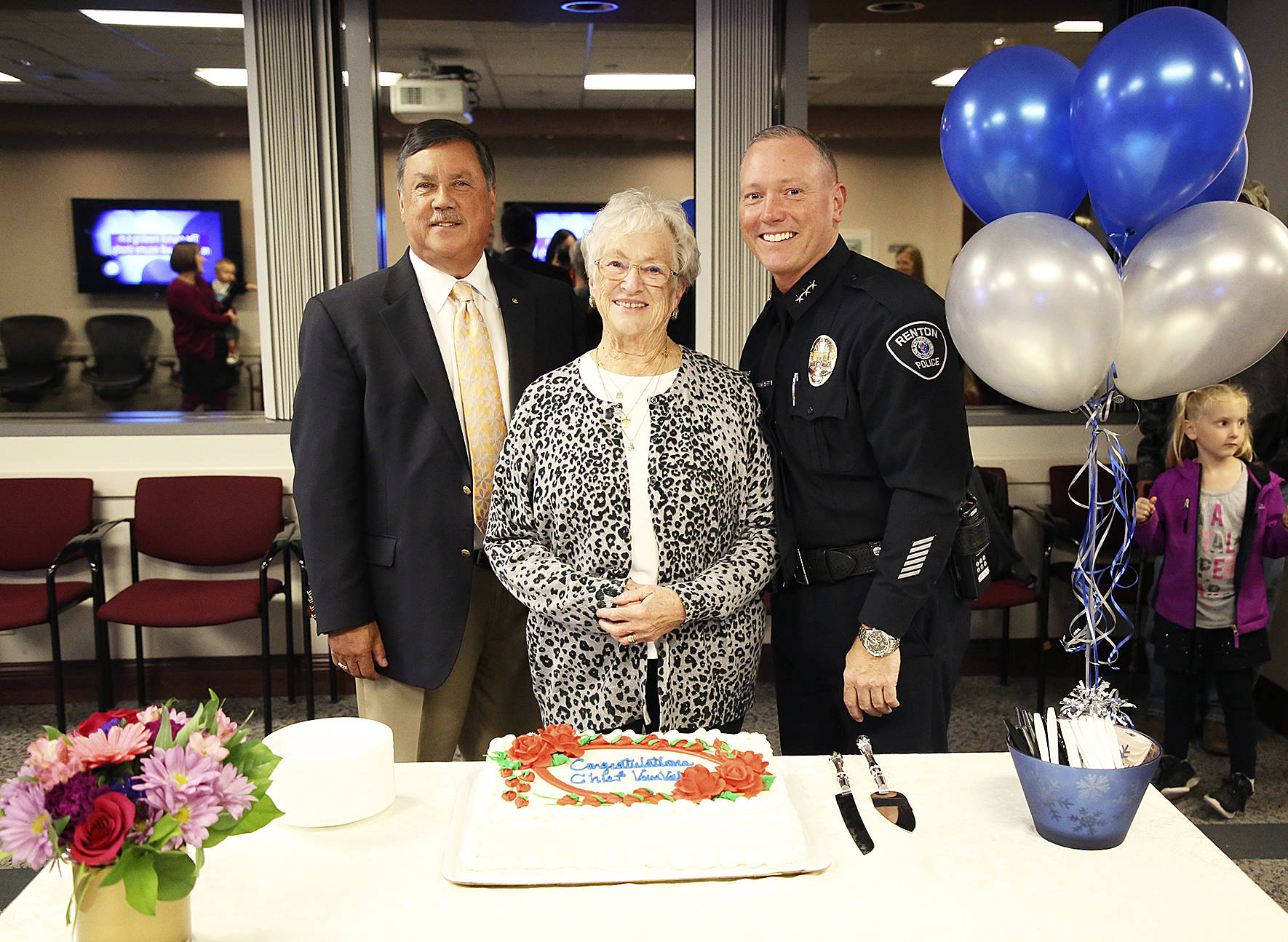 Mayor Denis Law, Police Chief Ed VanValey and his mother Jo Ann VanValey pose at the reception following his swearing in as new chief of police. Photo by Ava Van, City of Renton.