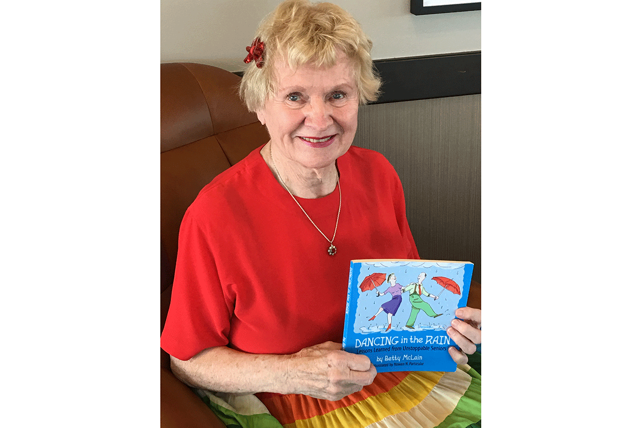 Betty McLain poses with a copy of her book she published in 2010. Courtesy photo.