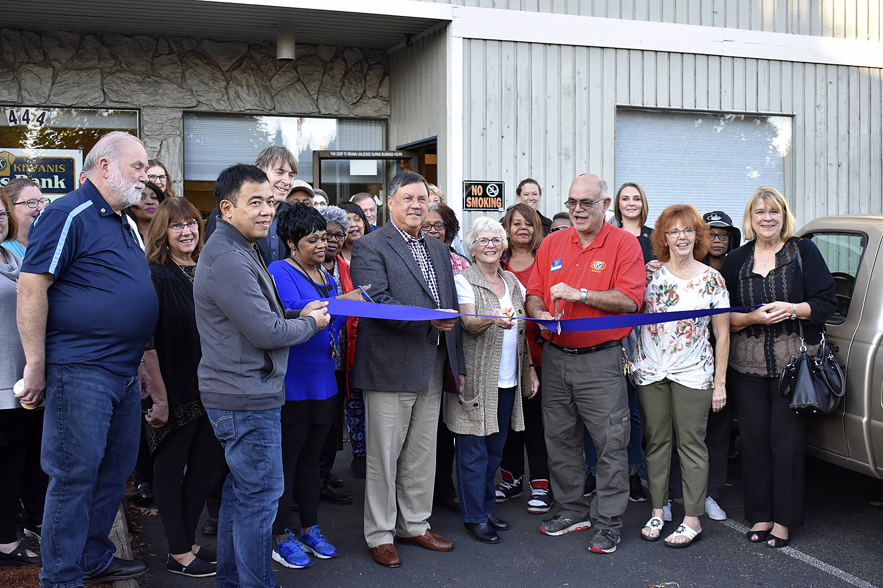 Photo By Haley Ausbun.                                The Renton Kiwanis Clothes Bank celebrates its new location with city and chamber representatives Oct. 16. The new location opened in May and offers clothing for those in need.