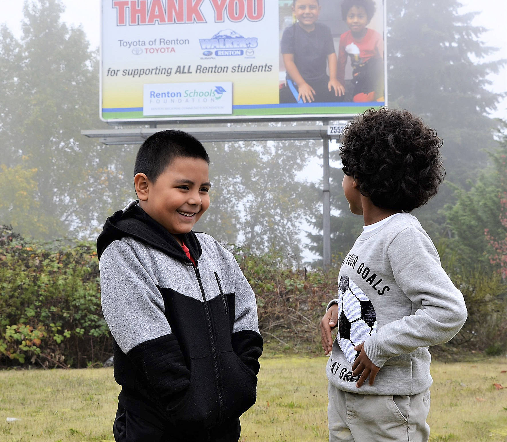 Photo courtesy of Renton Schools Foundation                                Campbell Hill Elementary student Adrian and Honey Dew Elementary student Isaac look at the billboard featuring them that thanks Walker’s Renton Subaru and Toyota of Renton for their support of Renton Schools Foundation.