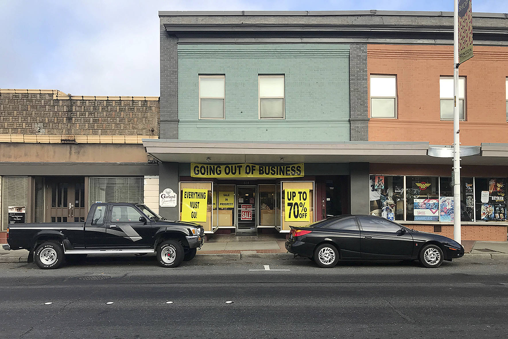 Garland Jewelers has sat in the main stretch of downtown over 60 years. As it closes this month, big yellow banners indicate the end of an era. Photo by Haley Ausbun.
