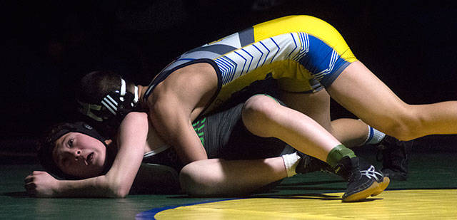 Erik Nguyen earns a takedown in the first period of the 106 pound match. Photo by Kayse Angel