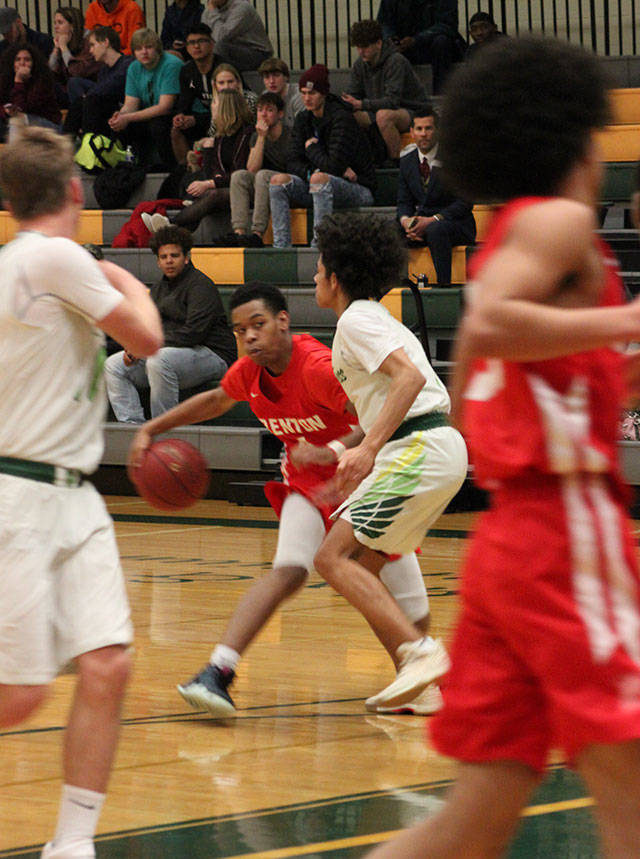 Senior guard Isaiah Littletries to shake his opponent. Photo by Sarah Brenden