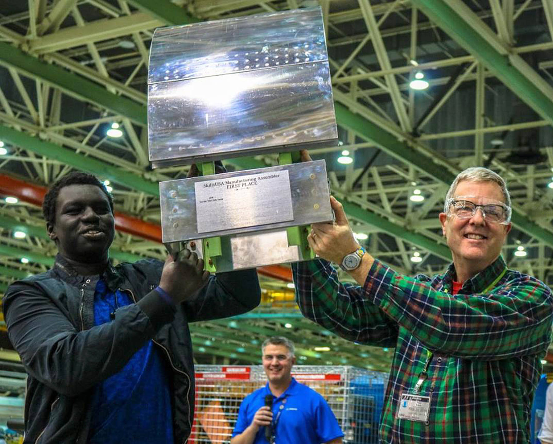 Moyaak Chuol, senior at Lindbergh High School, holds up his first place trophy with teacher Creed Nelson on Feb. 23. Chuol starts a job at Boeing after graduation. Courtesy of Creed Nelson.