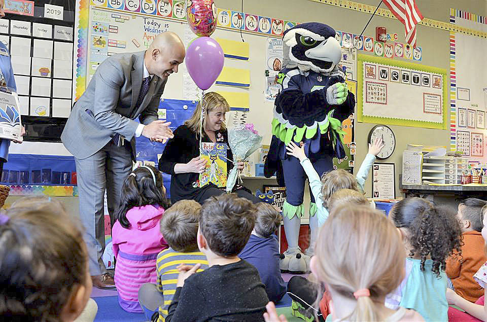 Photo courtesy Renton Schools Facebook page                                Tracy Dyson, from Hazelwood Elementary School, is one of the Renton Chamber of Commerce’s 2019 Ahead of the Class teachers. Renton Superintendent Dr. Damien Pattenaude and Blitz surprised Dyson April 3.