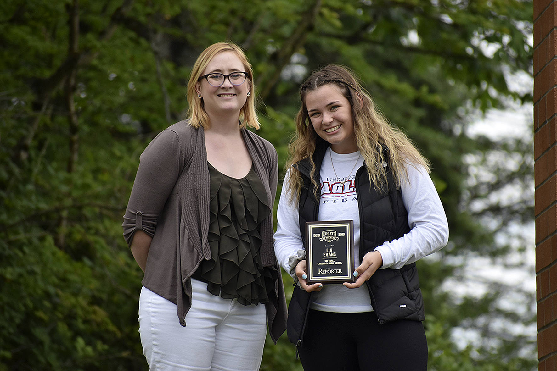The first ever Female Athlete of the Year for the Renton Reporter, Lia Evans (right) is awarded a plague from the Renton Reporter’s editor Danielle Chastaine (left).                                Photo by Haley Ausbun