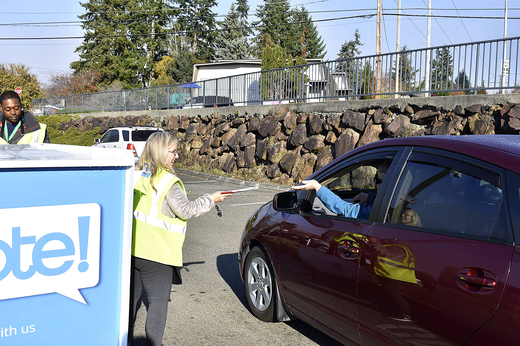 Photo by Haley Ausbun. Election Day in Renton, Nov. 5 2019. Election Office staff take a ballot from a drive-by voter.