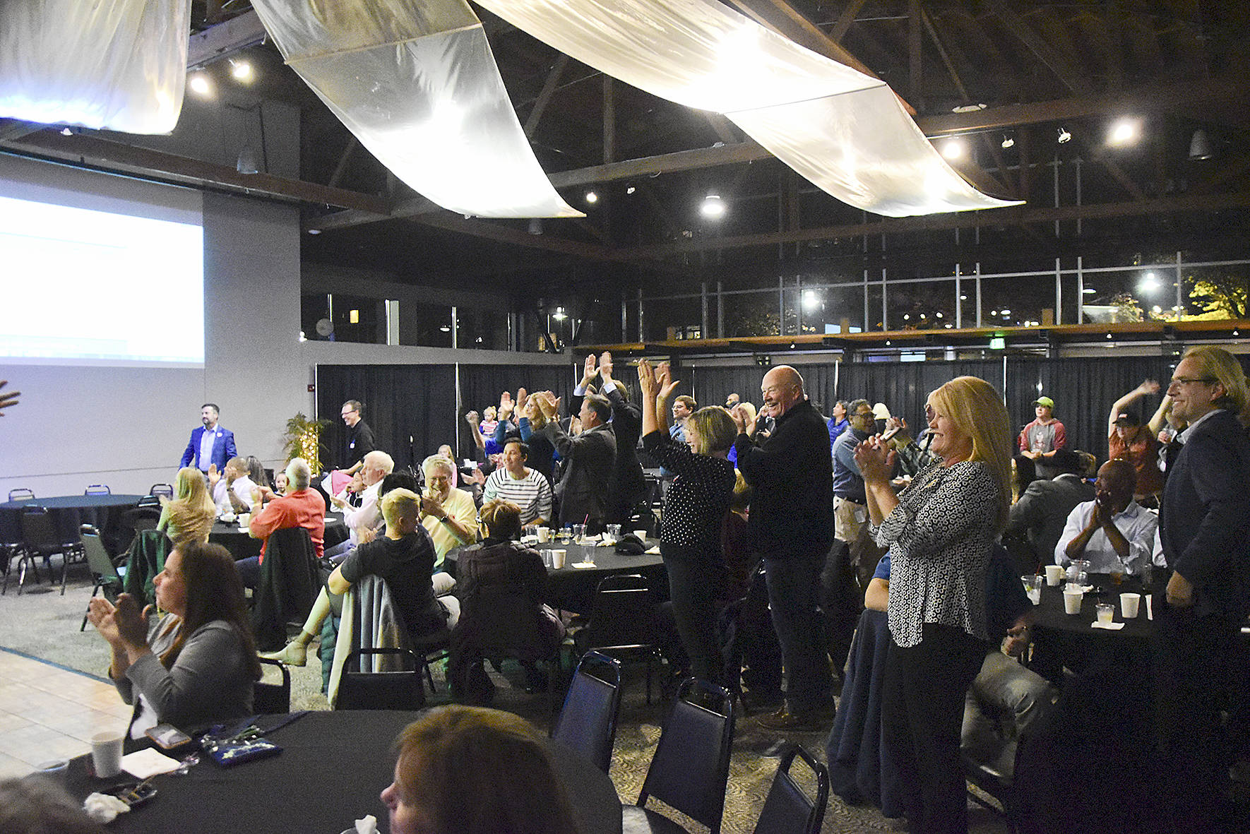 Photo by Gary Palmer. The crowd at Renton Pavillion Events Center including city elected officials, erupted in cheers as Armondo Pavone announced he was ahead in the initial election night results by 918 votes.