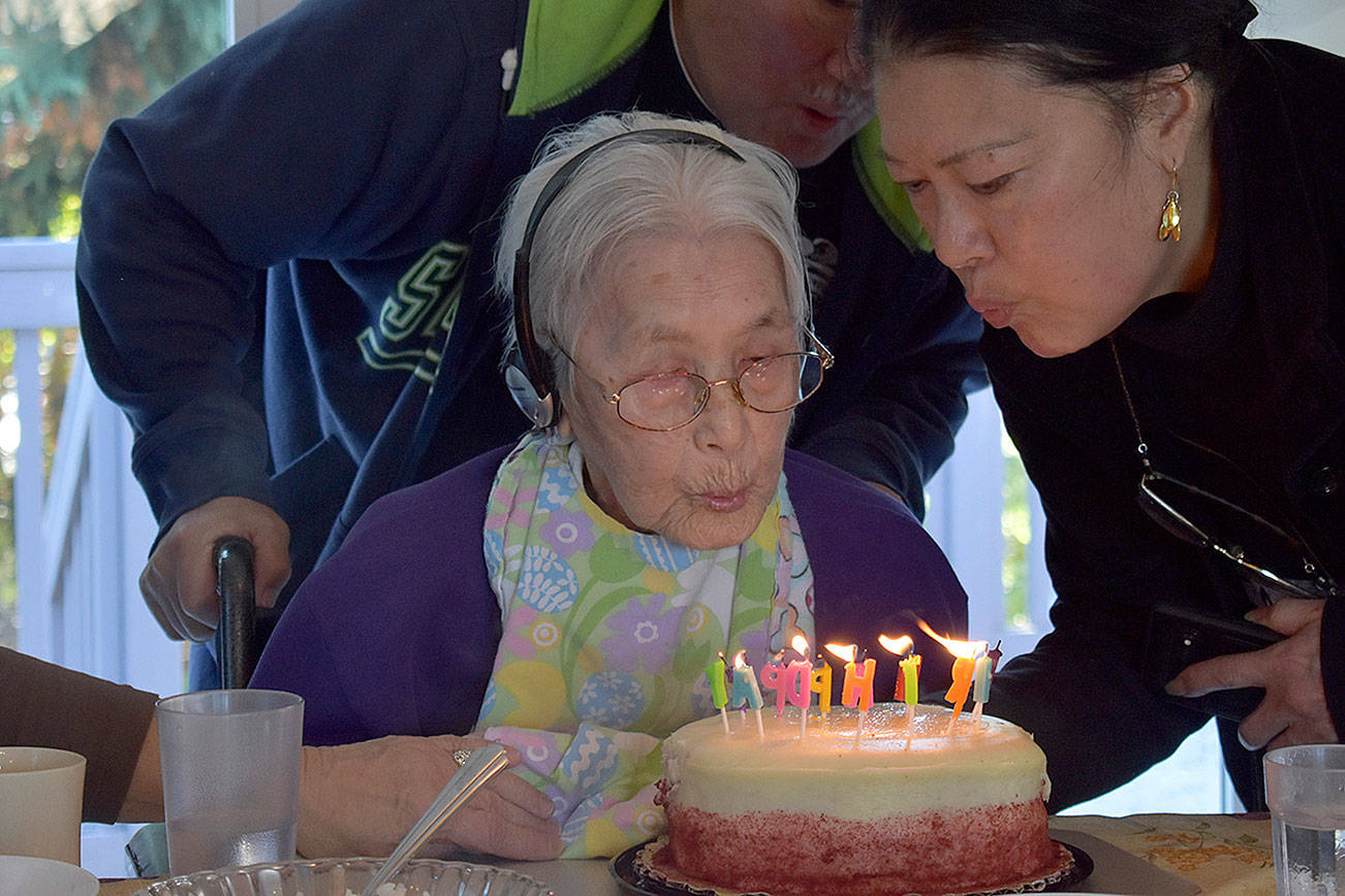 Photo by Haley Ausbun                                Satoko Hori blows out the birthday candles at her 100th birthday, with daughter Cathy Hori Emmons.