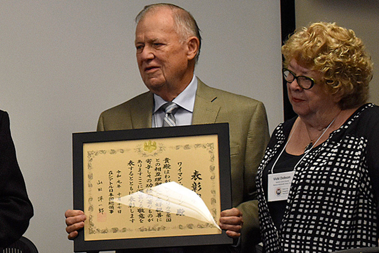 Photo by Haley Ausbun. Wyman and Vicky Dobson, as Wyman Dobson receives a certificate and medal for being a founder of the Nishiwaki-Renton sister cities. Wyman recently retired and sold his family building, where he had been an attorney for 59 years.