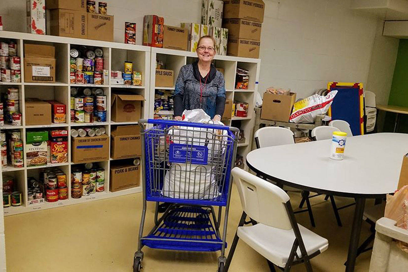 Photo courtesy of Marcie Palmer. REACH Center of Hope Donation Coordinator Pattie Holt with the last delivery from the 2019 Kennydale Neighborhood Association food drive, the day before Thanksgiving.