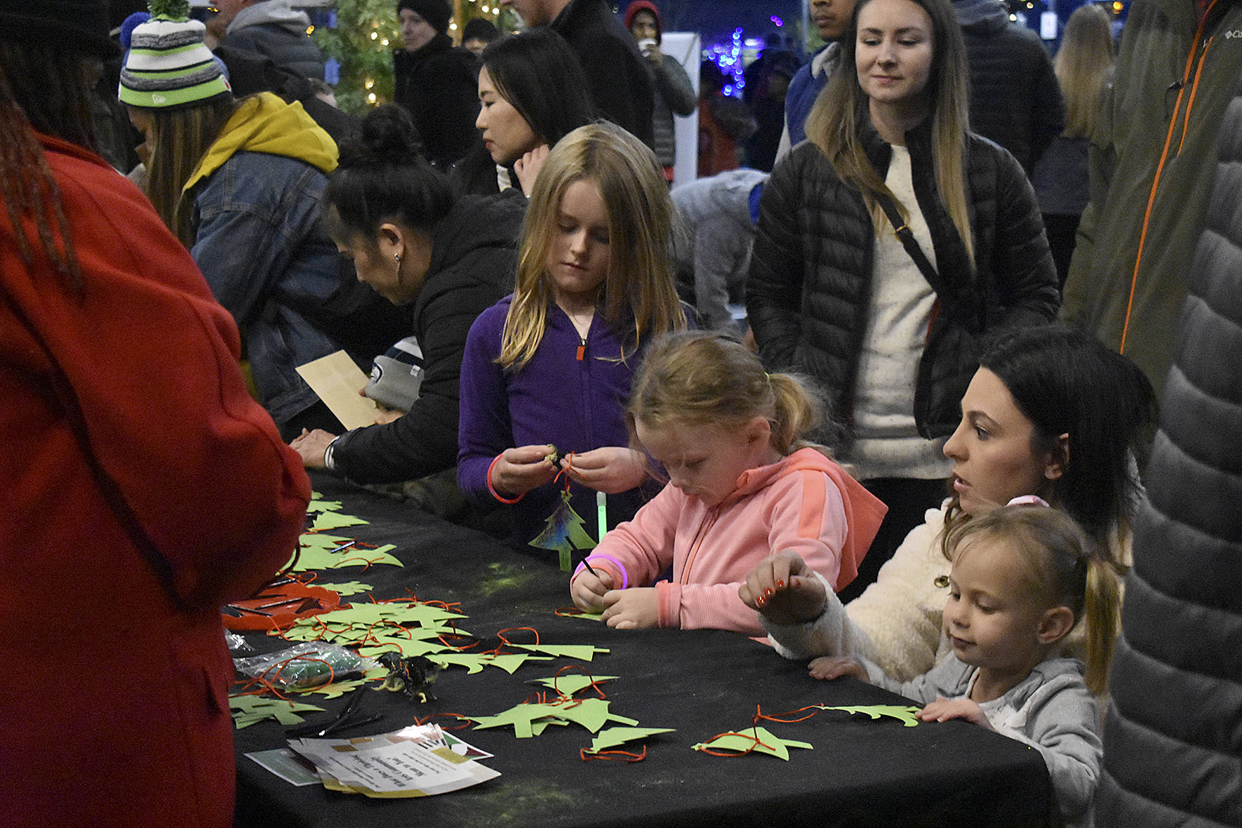 Photo by Haley Ausbun. Booths for kids to make Christmas tree decorations were one of the highlights at the pop-up market during the downtown tree lighting in Renton. Saturday, Nov. 30 at the Renton Pavilion Events Center.