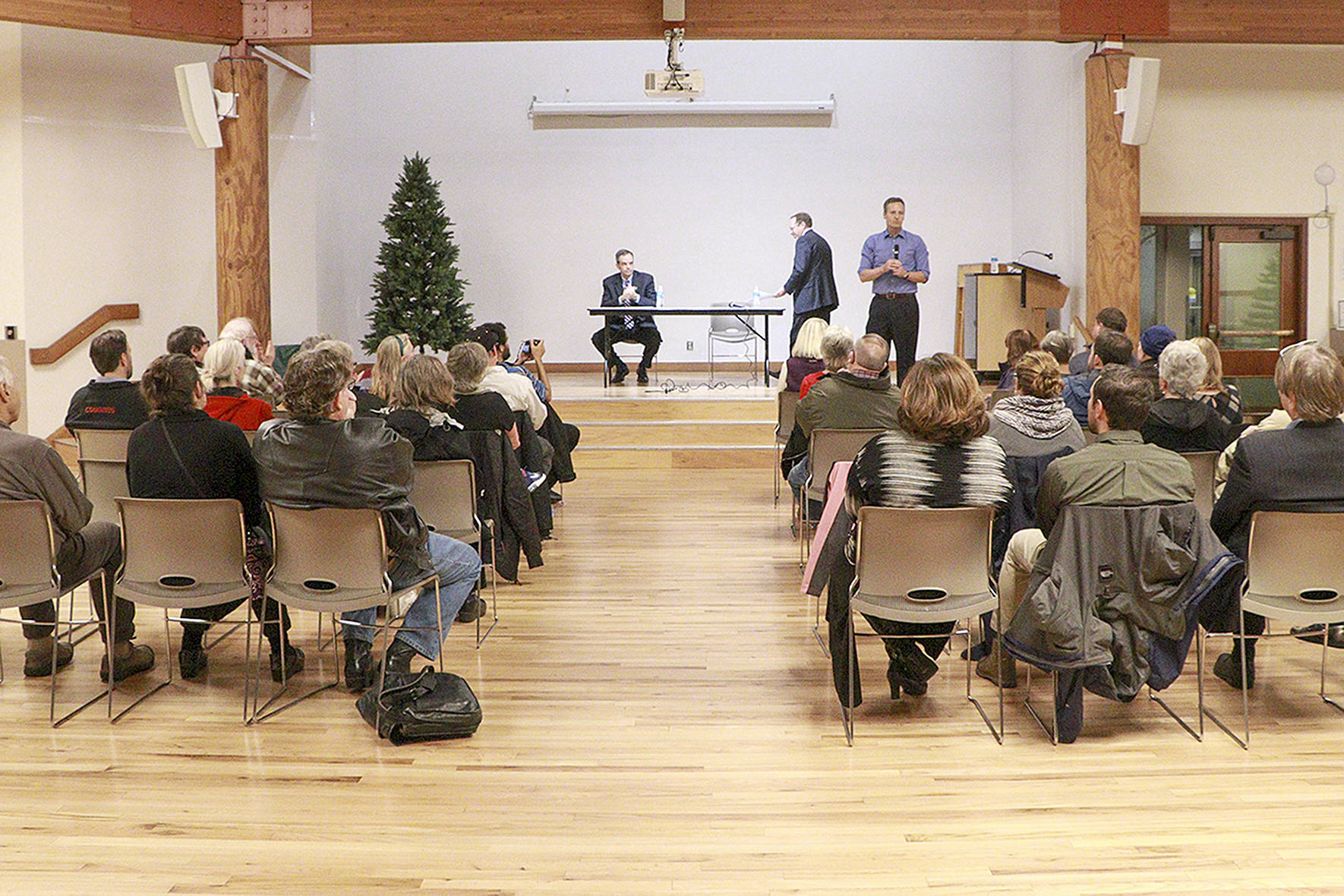 Photo courtesy Brennan Bunn. Rob Gannon, General Manager of King County Metro Transit, and Peter Rogoff, CEO of Sound Transit, and King County Councilmember Dave Upthegrove onstage at the Transit Town Hall, Dec. 4, at Renton Senior Activity Center.