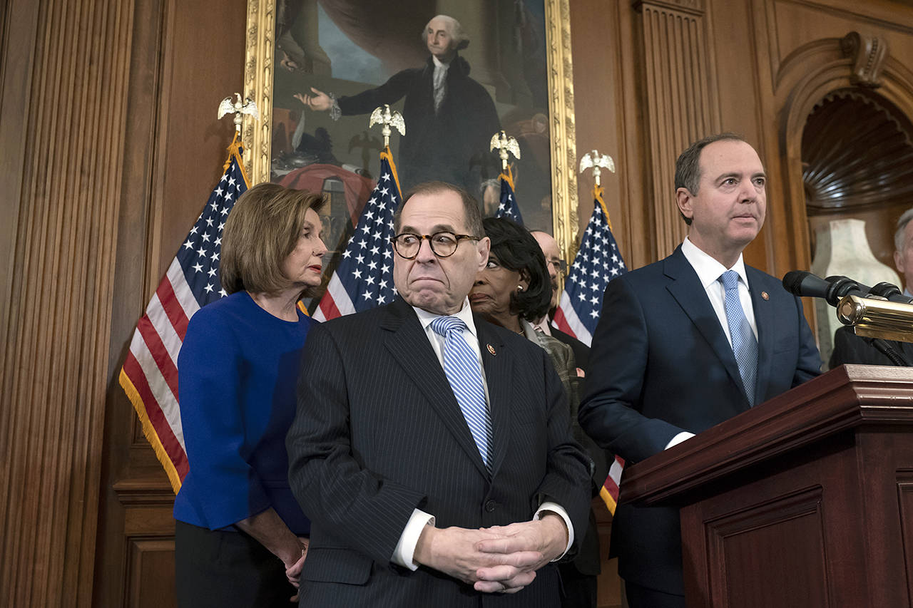 From left, Speaker of the House Nancy Pelosi, House Judiciary Committee Chairman Jerrold Nadler, D-N.Y., House Financial Services Committee Chairwoman Maxine Waters, D-Calif., House Foreign Affairs Committee Chairman Eliot Engel, D-N.Y., and House Intelligence Committee Chairman Adam Schiff, D-Calif., announce they are pushing ahead with two articles of impeachment against President Donald Trump — abuse of power and obstruction of Congress — charging he corrupted the U.S. election process and endangered national security in his dealings with Ukraine, at the Capitol in Washington on Tuesday. (AP Photo/J. Scott Applewhite)