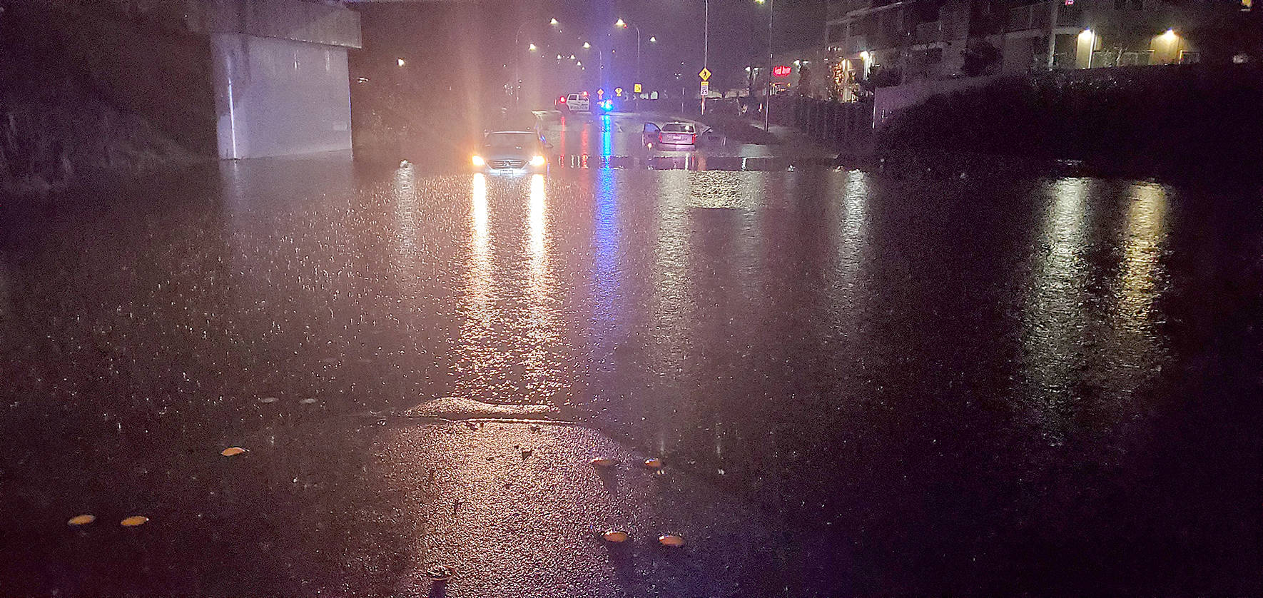 Photo courtesy of Renton Police Department. A car was stuck early Friday, Dec. 20 on Hardie Avenue Southwest below the railway bridge, as flooding closed a few city streets.