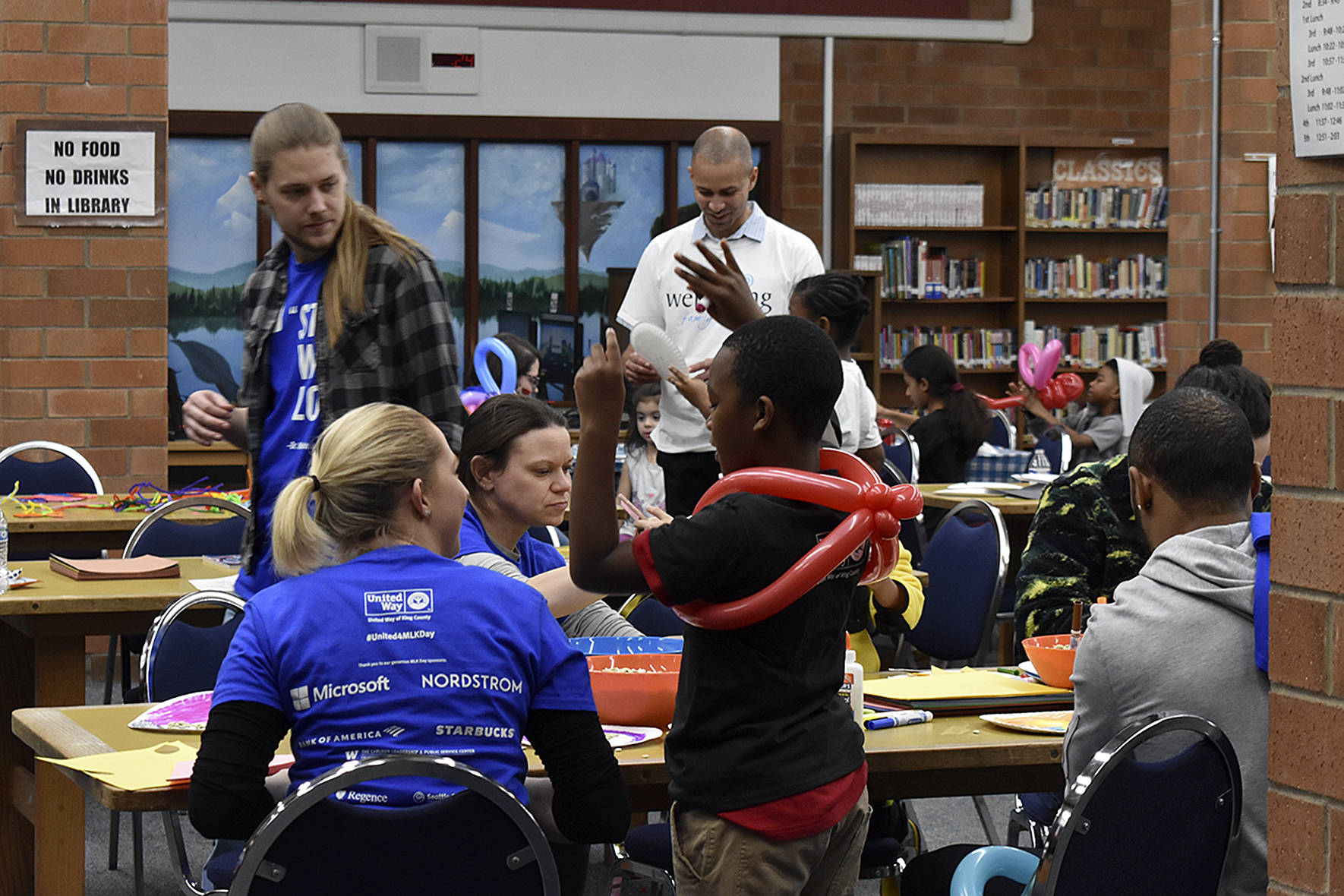 Photo by Haley Ausbun. In the Lindbergh High School library, United Way volunteers watched kids and small children while their parents talked to housing assistance providers at the Family Resource Exchange event on Martin Luther King Jr. Day, Jan. 20.