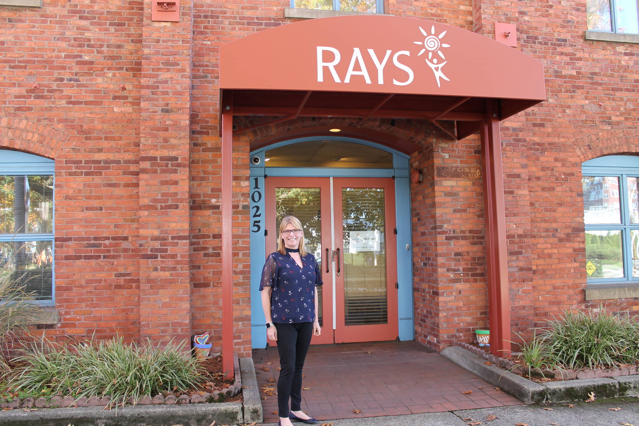 Michelle Hankinson stands in front of the Renton Area Youth Services office in downtown Renton. While RAYS is merging with two other nonprofits, much of it remains the same. Courtesy photo RAYS.
