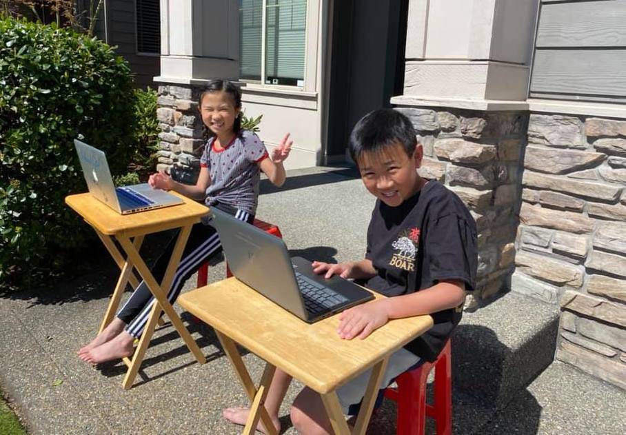 Two Renton School District students doing in-home learning, outside last spring. Courtesy photo/ Renton Schools Facebook page.