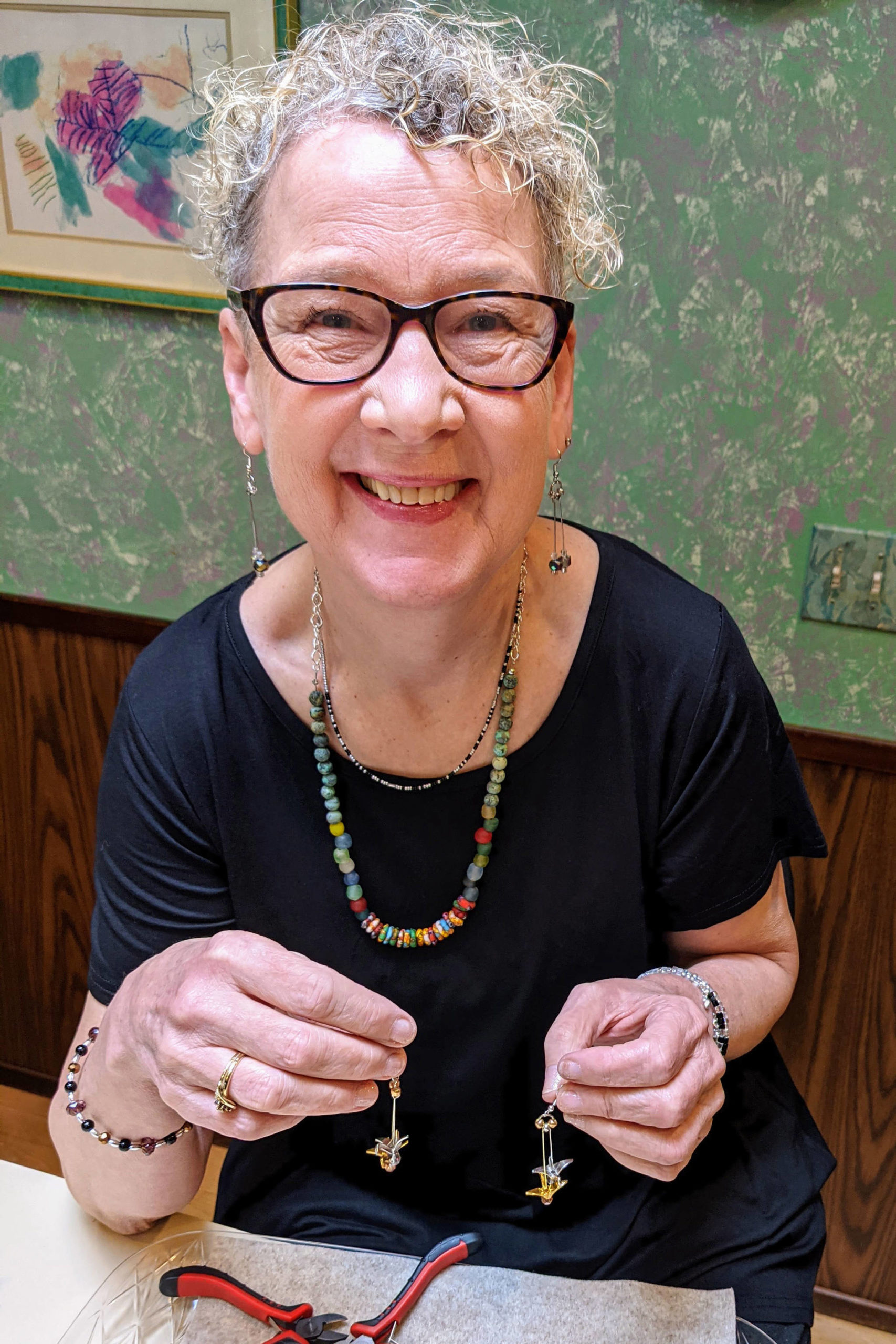 Liz Falconer smiling as she crafts jewelry (photo credit: Liz Falconer)