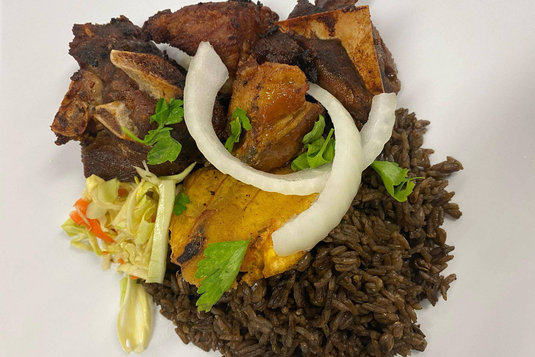 Griot (fried pork dish) photo courtesy of Juju’s Caribbean Kitchen
