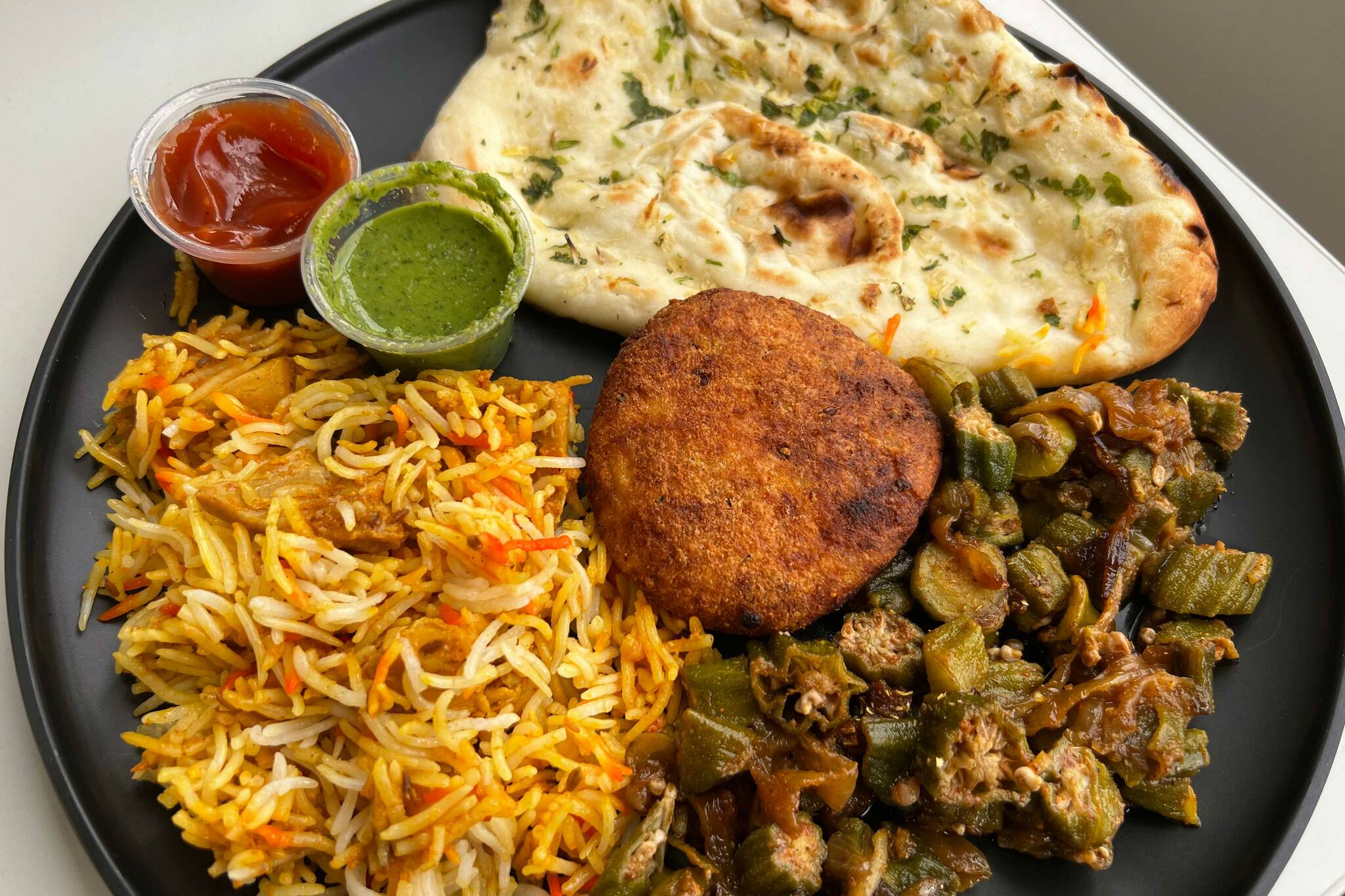 Garlic Naan, Paneer Kebab, Biryani Chicken and Bhindi Masala from Rice-N-Curry (Photo by Cameron Sheppard/Sound Publishing)