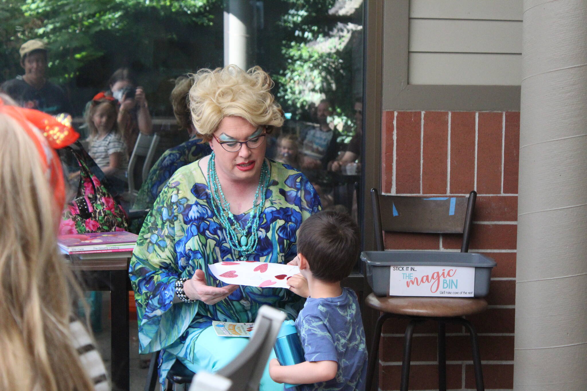 Sylvia receives a homemade card from one of the kids at Drag Queen Storytime. Photo by Bailey Jo Josie/Sound Publishing.