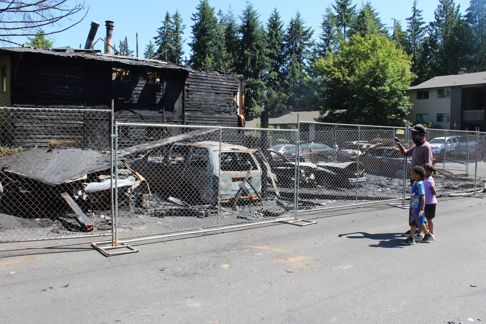 Shepherd Edwards, a resident of Cascadia apartments, stands with family members opposite of where the fire originated. "I feel bad about it," Edwards said. "A lot of people are out of a home." Edwards and his family's apartment is in another building in the complex. Photo by Bailey Jo Josie/Sound Publishing.
