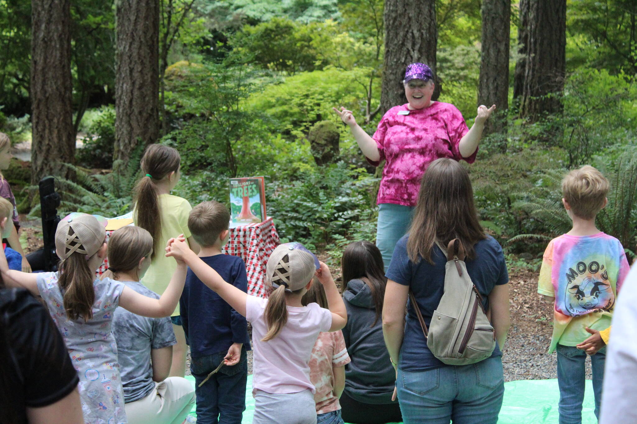 Chastain leads the children in a song between books during the Tree Tour. Photo by Bailey Jo Josie/Sound Publishing.