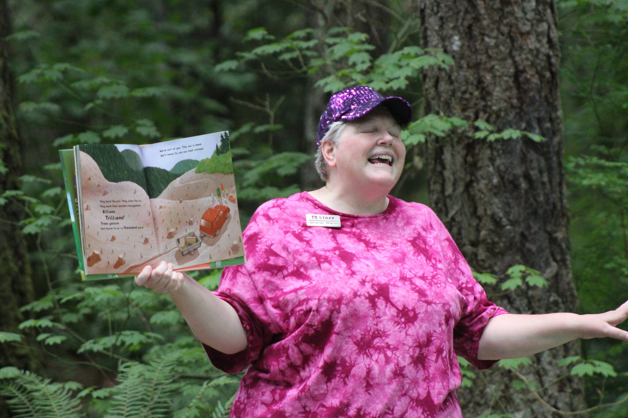 Chastain reads "Trillions Of Trees" to the crowd in the Lake Wilderness Arboretum. Photo by Bailey Jo Josie/Sound Publishing.