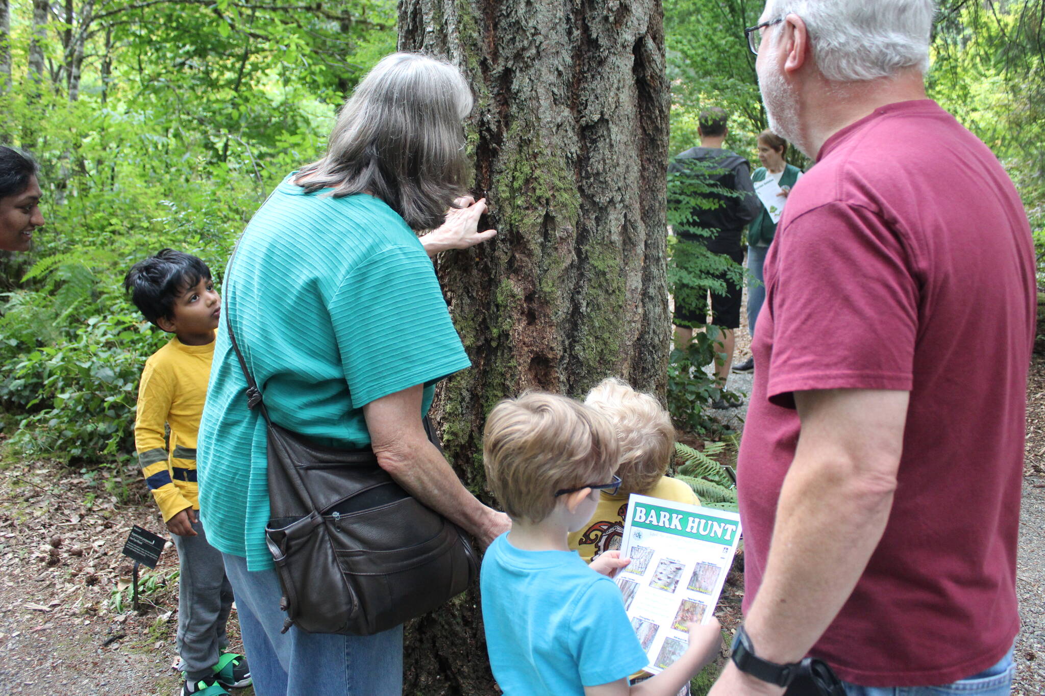 As part of the Tree Tour, everyone was encouraged to touch, smell and even listen to the bark on the trees of the Arboretum. Photo by Bailey Jo Josie/Sound Publishing.