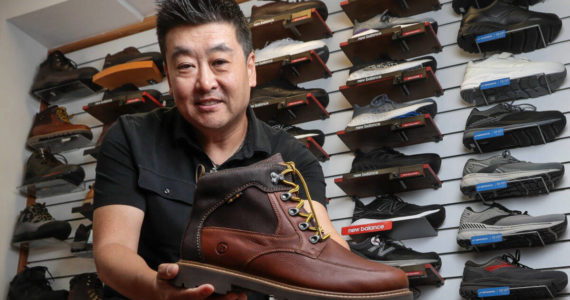 At two stores – in Edmonds and Renton – Wide Shoes Only store owner Dominic Ahn offers more than 600 styles of shoes for people with wide feet. (Kevin Clark / The Herald)