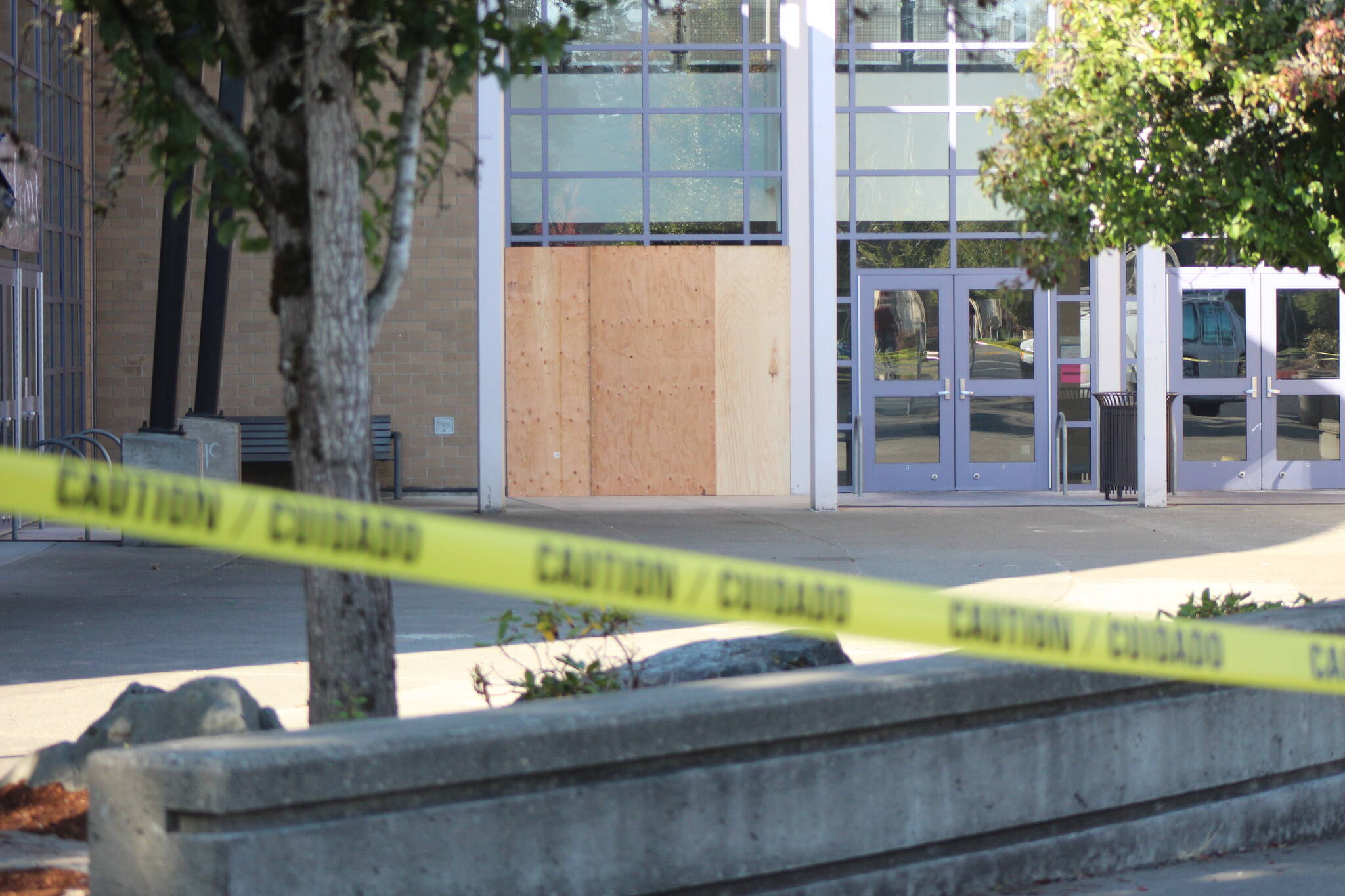 Hours after the early morning crash, plywood had covered the site of the crash and caution tape bordered the front of Hazen High School. Photo by Bailey Jo Josie/Sound Publishing.